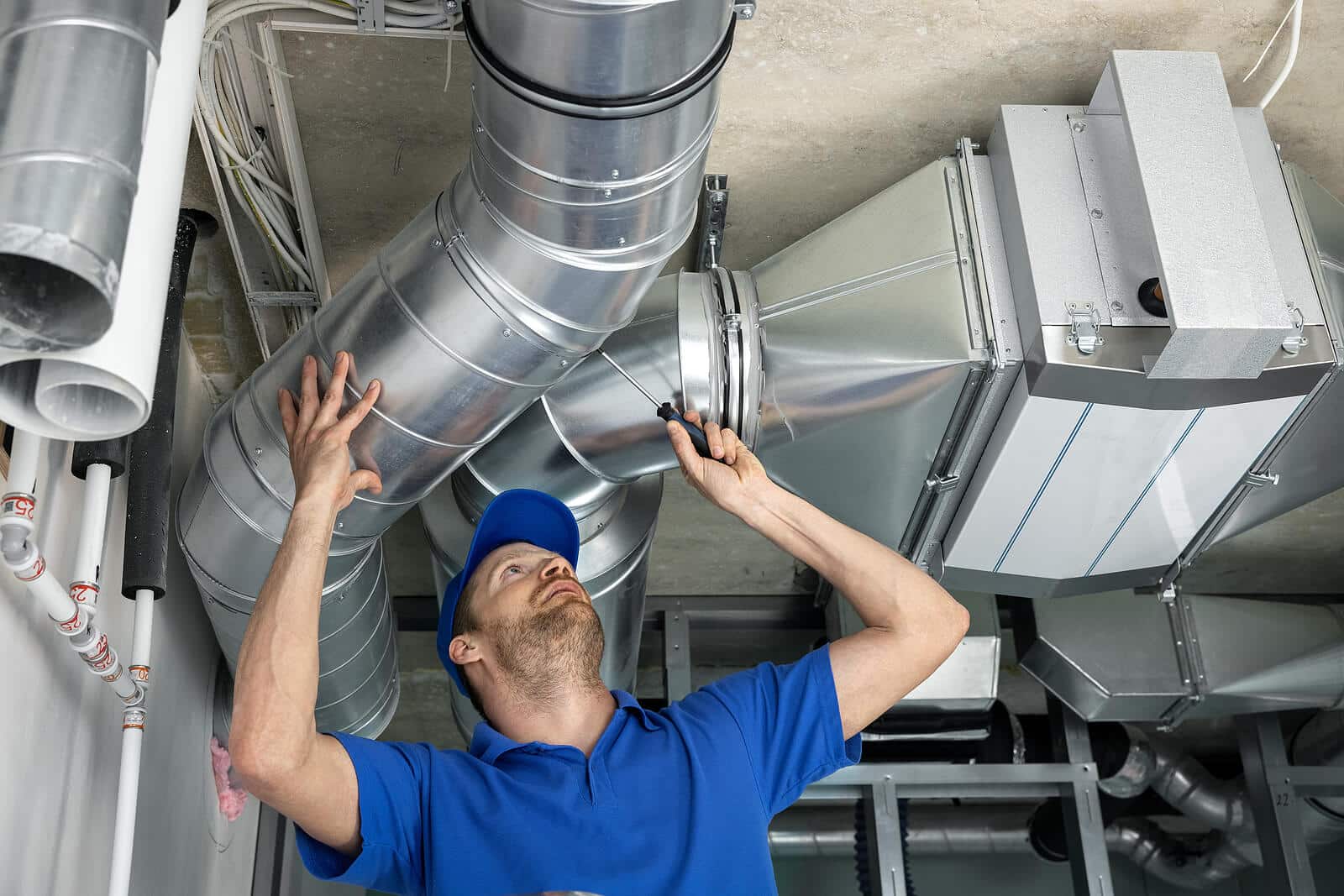 HVAC technician inspecting and repairing air ducts in Woodland